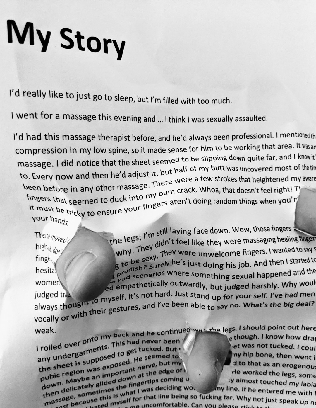 Fingers poking through a page where my story is written