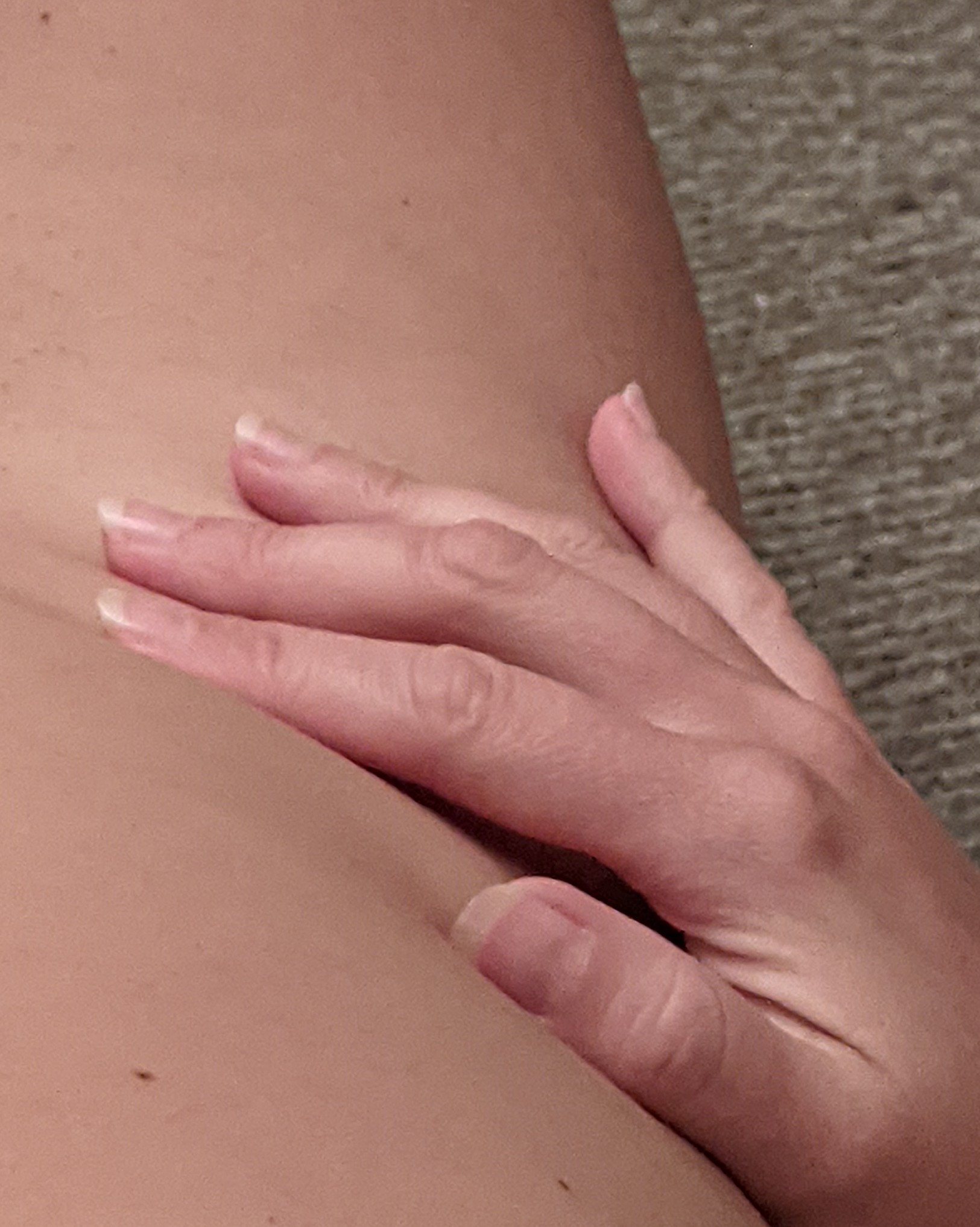 Right hand resting on a nude hip